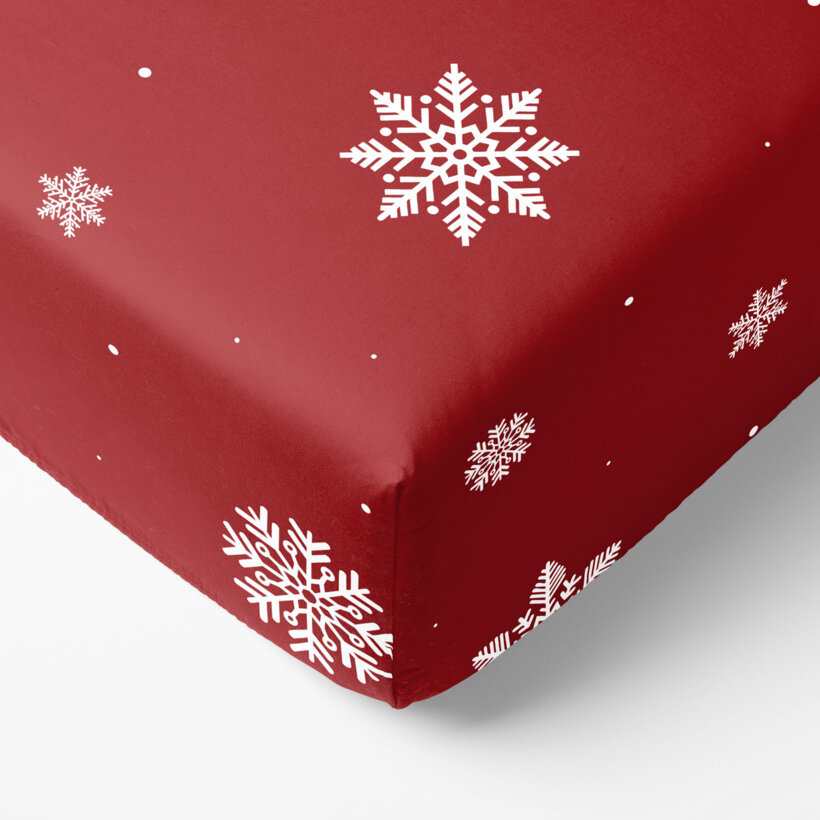 Weihnachtliches Spannbettlaken aus Baumwolle - Schneeflocken auf Rot