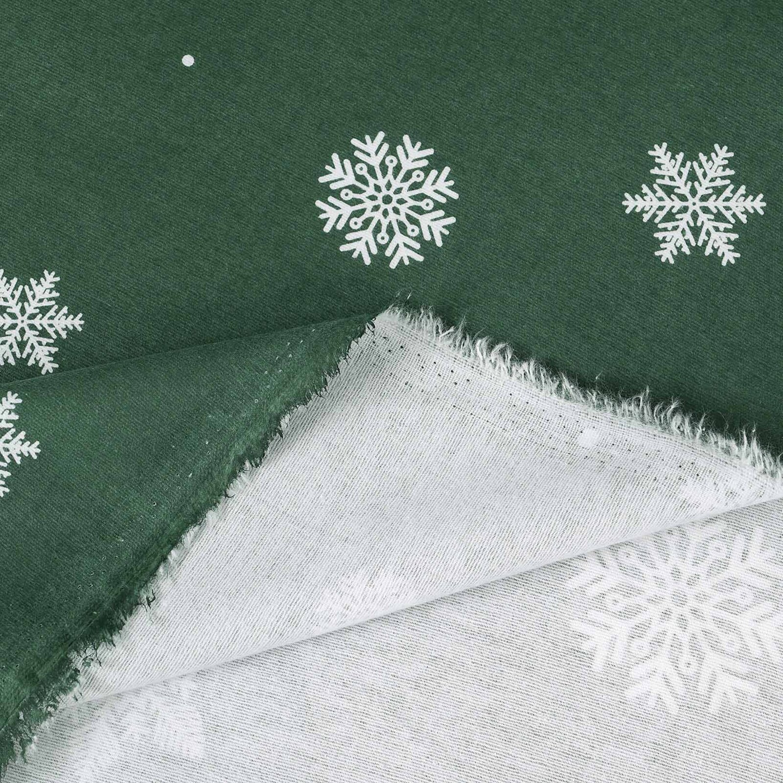 Weihnachtlicher Flanellstoff - Schneeflocken auf Grün